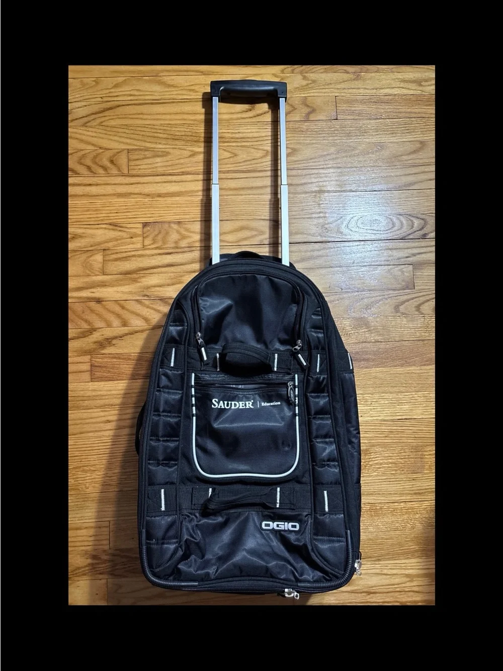 Ogio Pull Through Rolling 23” Travel Bag Suitcase with company logo on the front